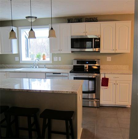 24 Stinson Road Andover, MA 01810 - Photo 5 of 22 a kitchen with a stove and a microwave