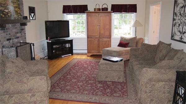 24 Stinson Road Andover, MA 01810 - Photo 9 of 22 a living room with furniture and a flat screen tv