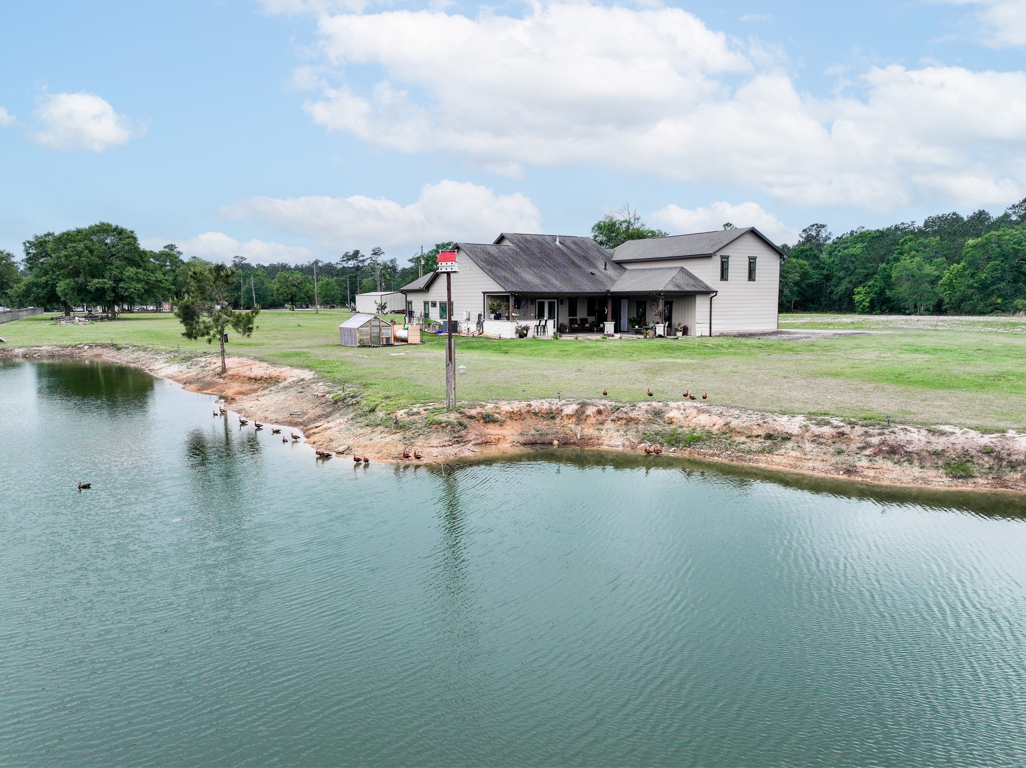 10573 Cooks Lake Road Lumberton, TX 77657 - Photo 41 of 47 a view of a lake with a big yard and large trees