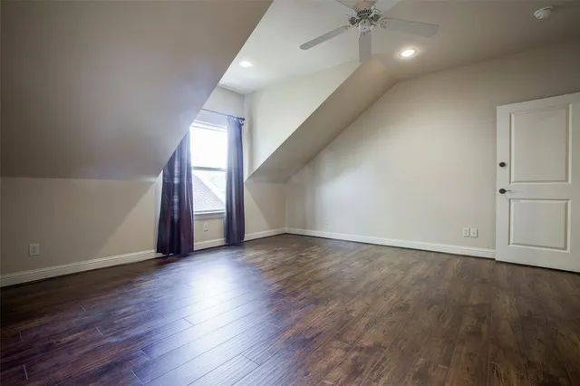 an empty room with wooden floor and a window