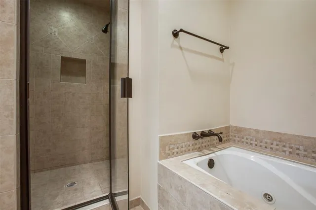 a bathroom with a tub and shower