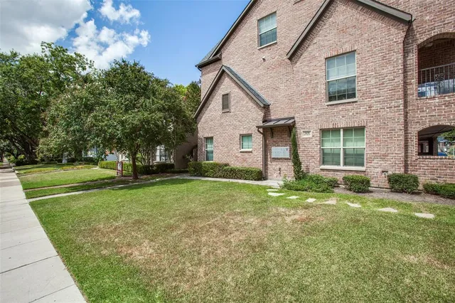 a view of backyard of house with green space