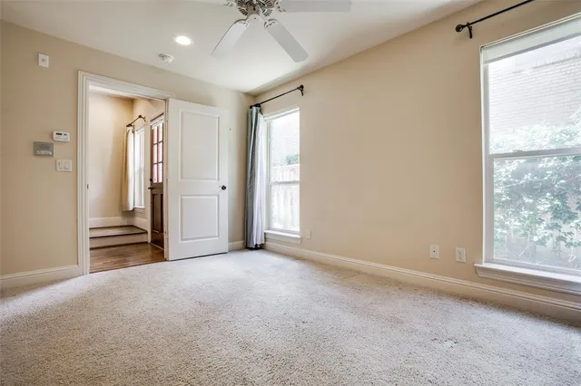 an empty room with windows and closet