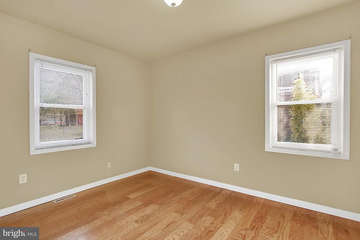 333 Back River Neck Road Baltimore, MD 21221 - Photo 10 of 25 a view of an empty room with wooden floor and a window