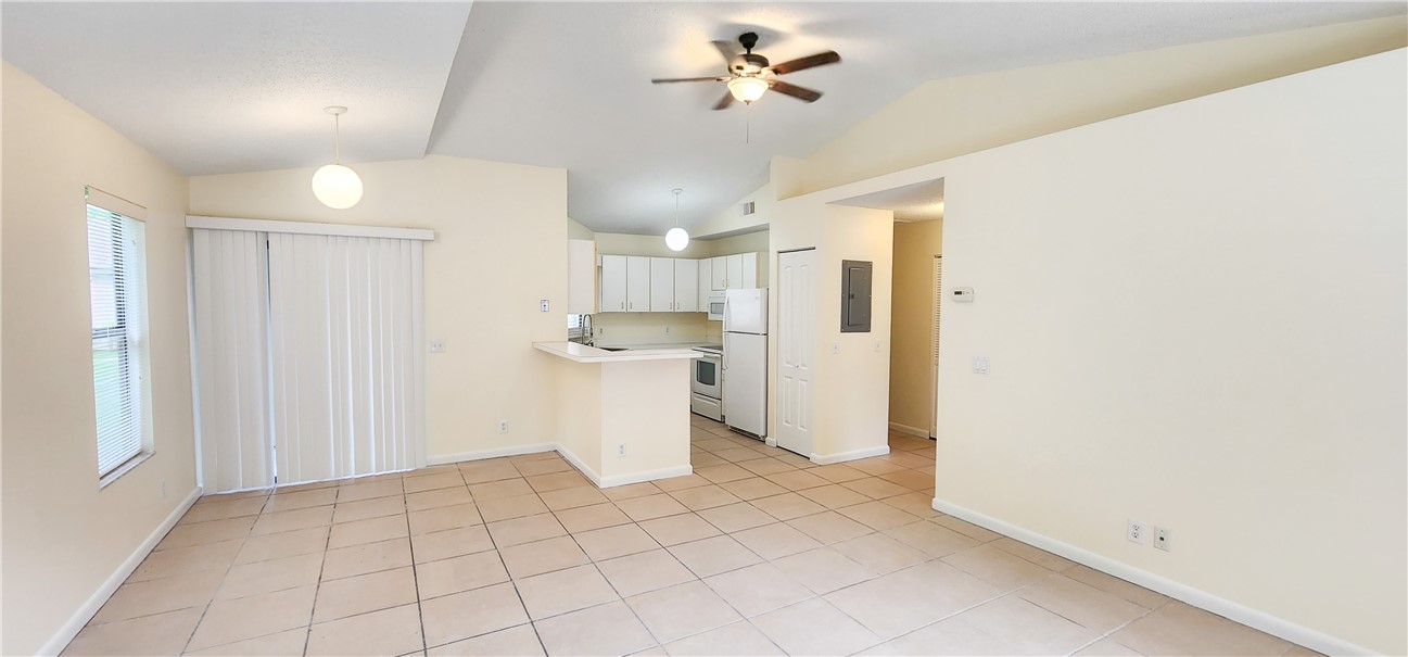 2820 Stoneway Lane, Unit C Fort Pierce, FL 34982 - Photo 1 of 13 a view of a kitchen with a refrigerator and a window