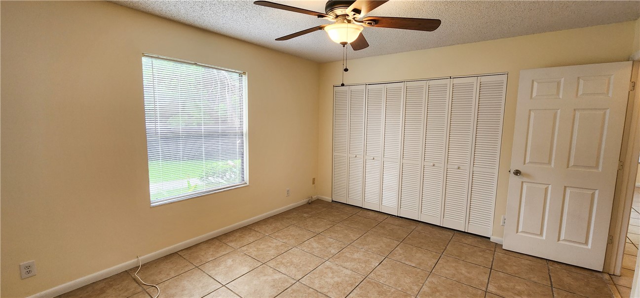 2820 Stoneway Lane, Unit C Fort Pierce, FL 34982 - Photo 12 of 13 a view of an empty room with a window