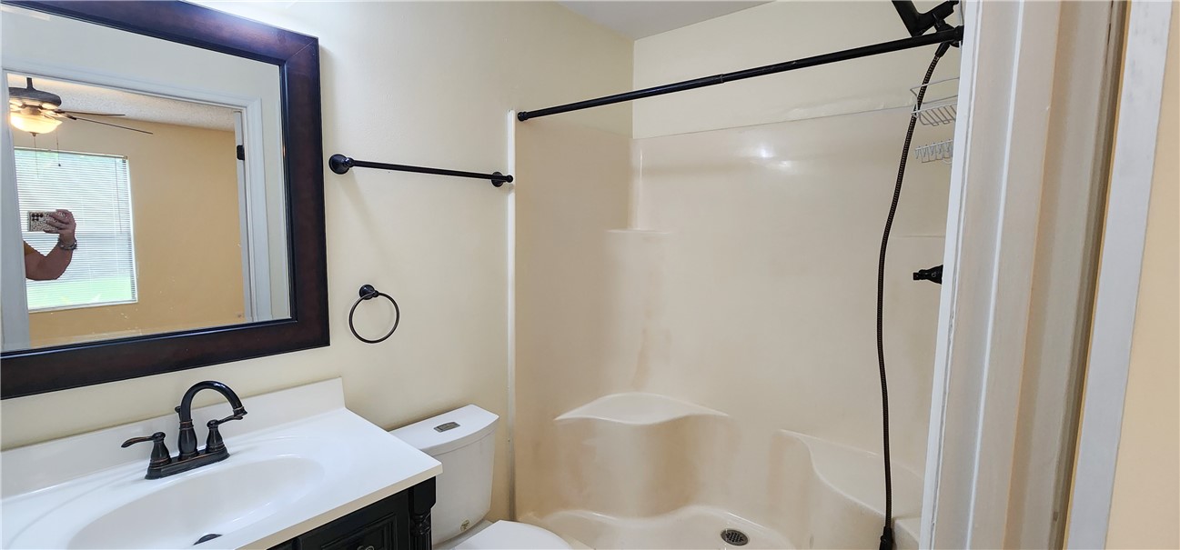 2820 Stoneway Lane, Unit C Fort Pierce, FL 34982 - Photo 13 of 13 a bathroom with a sink mirror toilet and shower