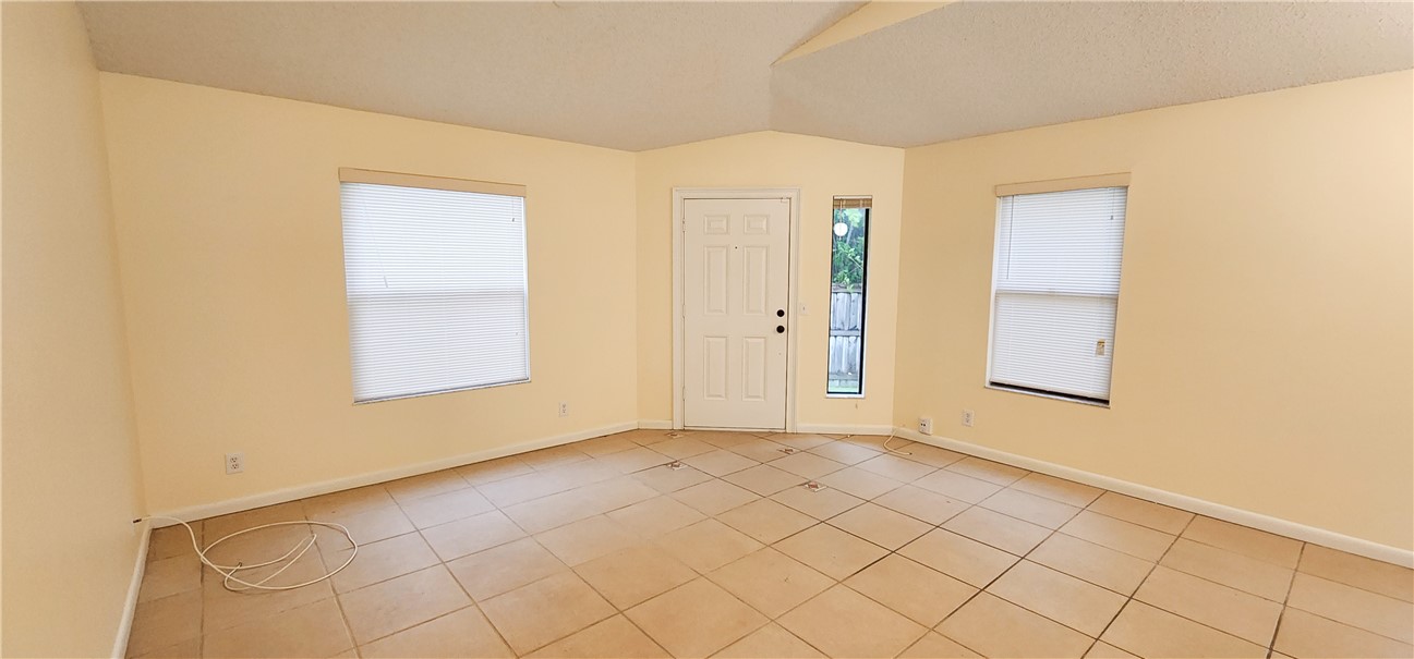 2820 Stoneway Lane, Unit C Fort Pierce, FL 34982 - Photo 5 of 13 an empty room with windows