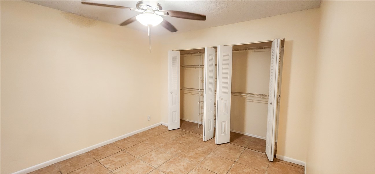 2820 Stoneway Lane, Unit C Fort Pierce, FL 34982 - Photo 8 of 13 a view of empty room with ceiling fan