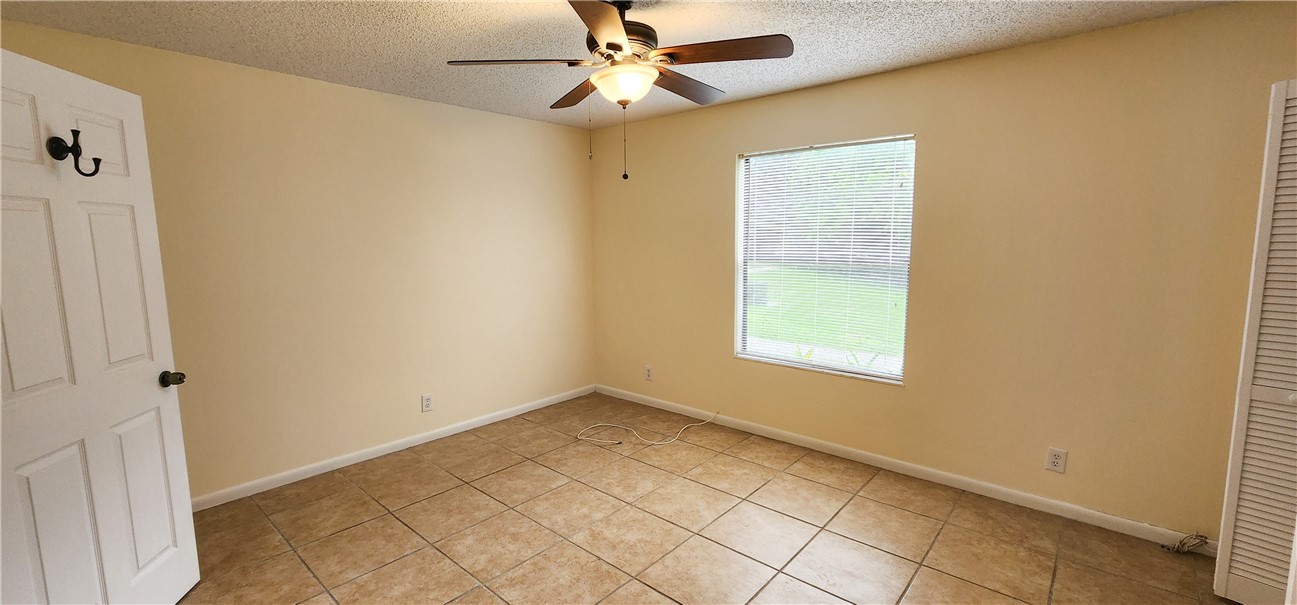2820 Stoneway Lane, Unit C Fort Pierce, FL 34982 - Photo 10 of 13 a view of an empty room with a window