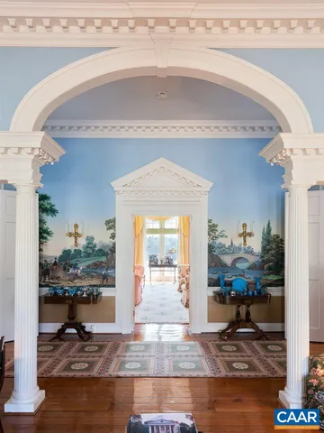 a spacious bedroom with a bed and wooden floor
