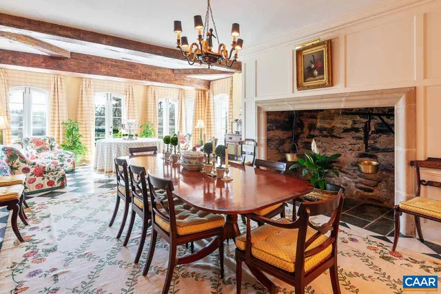 a living room with furniture a flat screen tv and windows