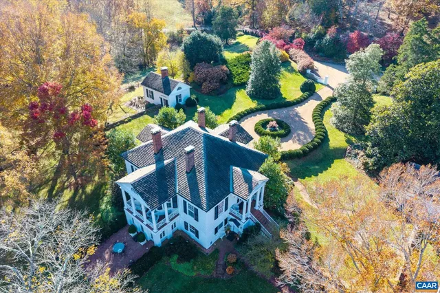 an aerial view of a house with a yard and garden