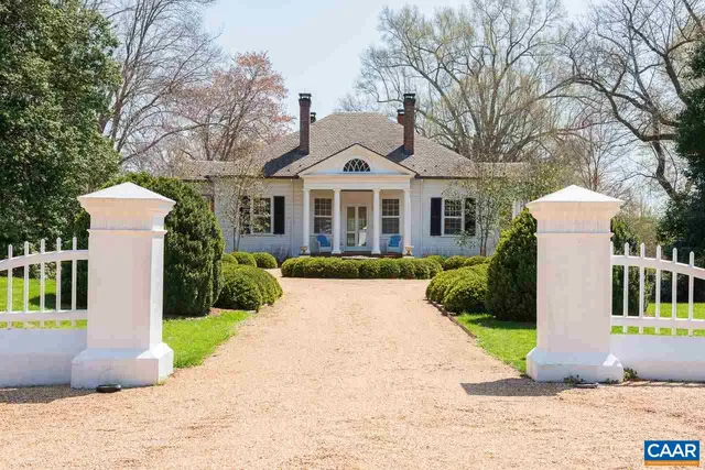 a living room with fireplace furniture and a chandelier