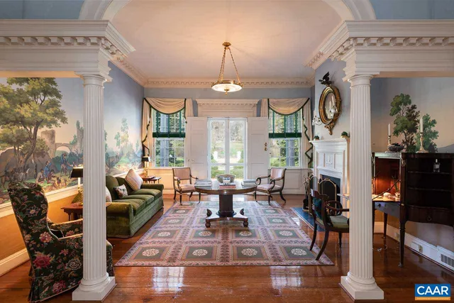 a living room filled with furniture and a floor to ceiling window