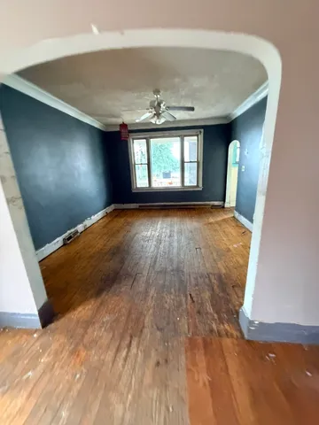 wooden floor in an empty room with a window