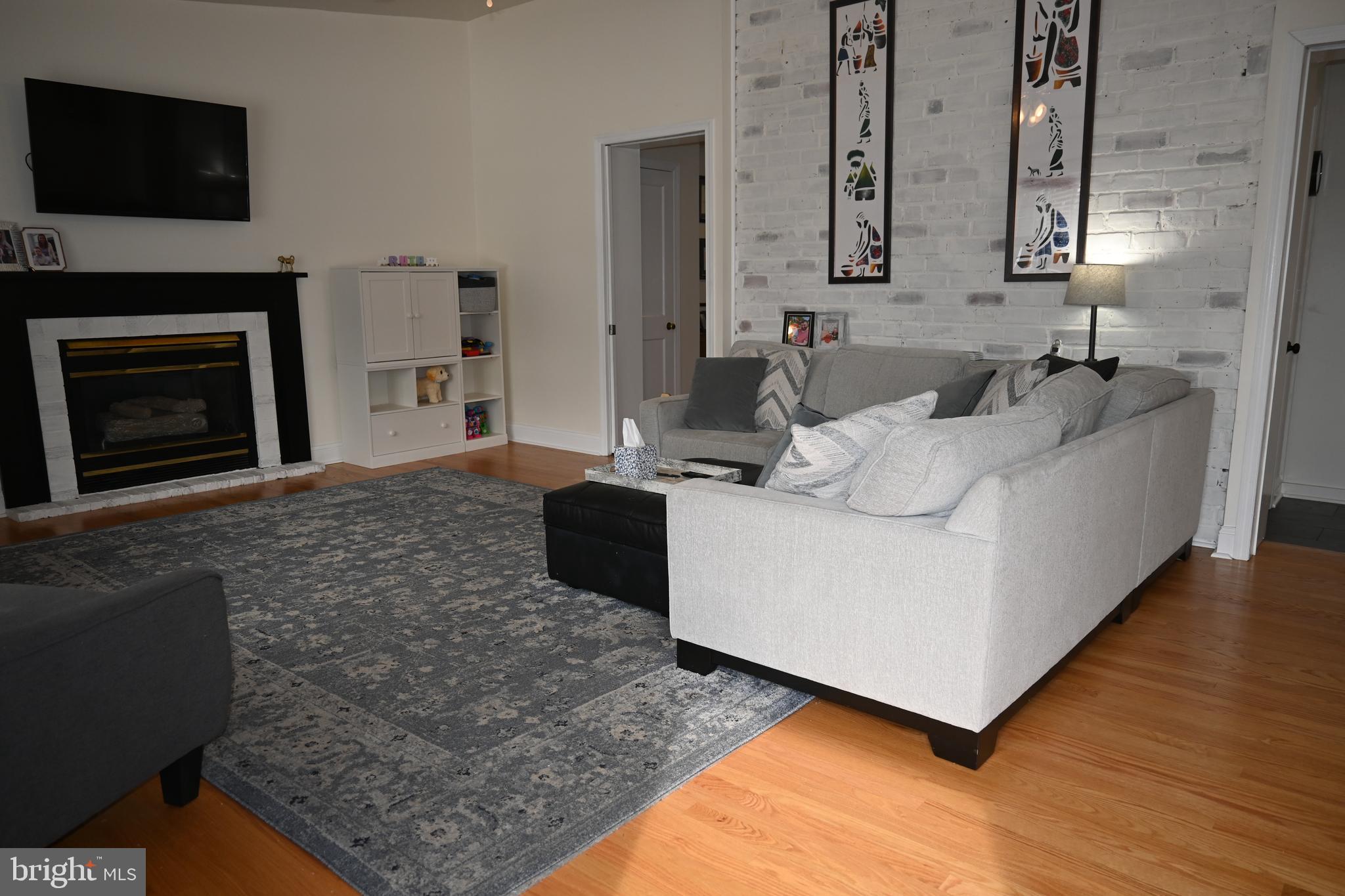 514 Springview Lane Springfield, PA 19064 - Photo 13 of 33 a living room with furniture and a fireplace