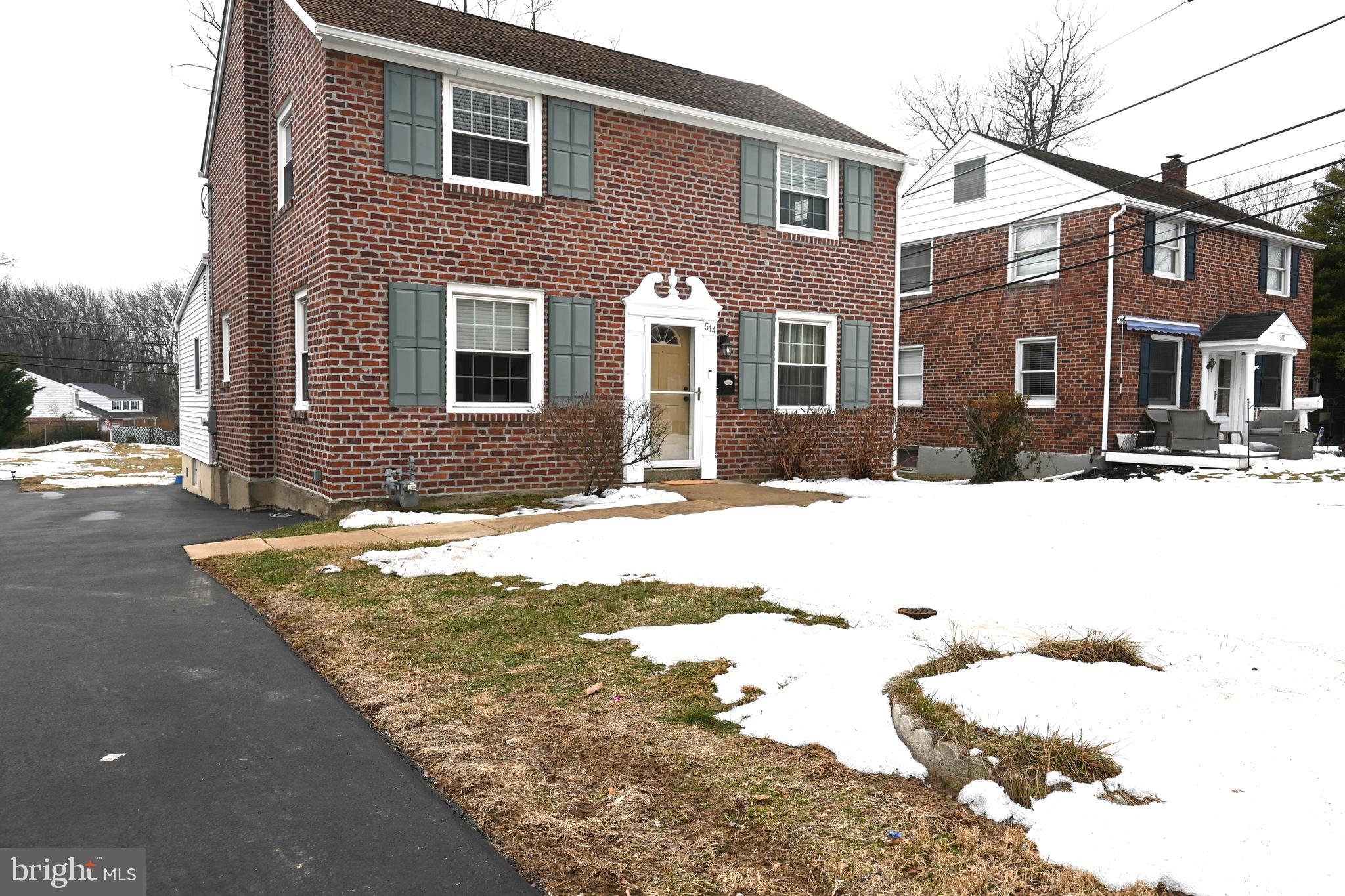 514 Springview Lane Springfield, PA 19064 - Photo 33 of 33 a front view of a house with a yard covered in snow