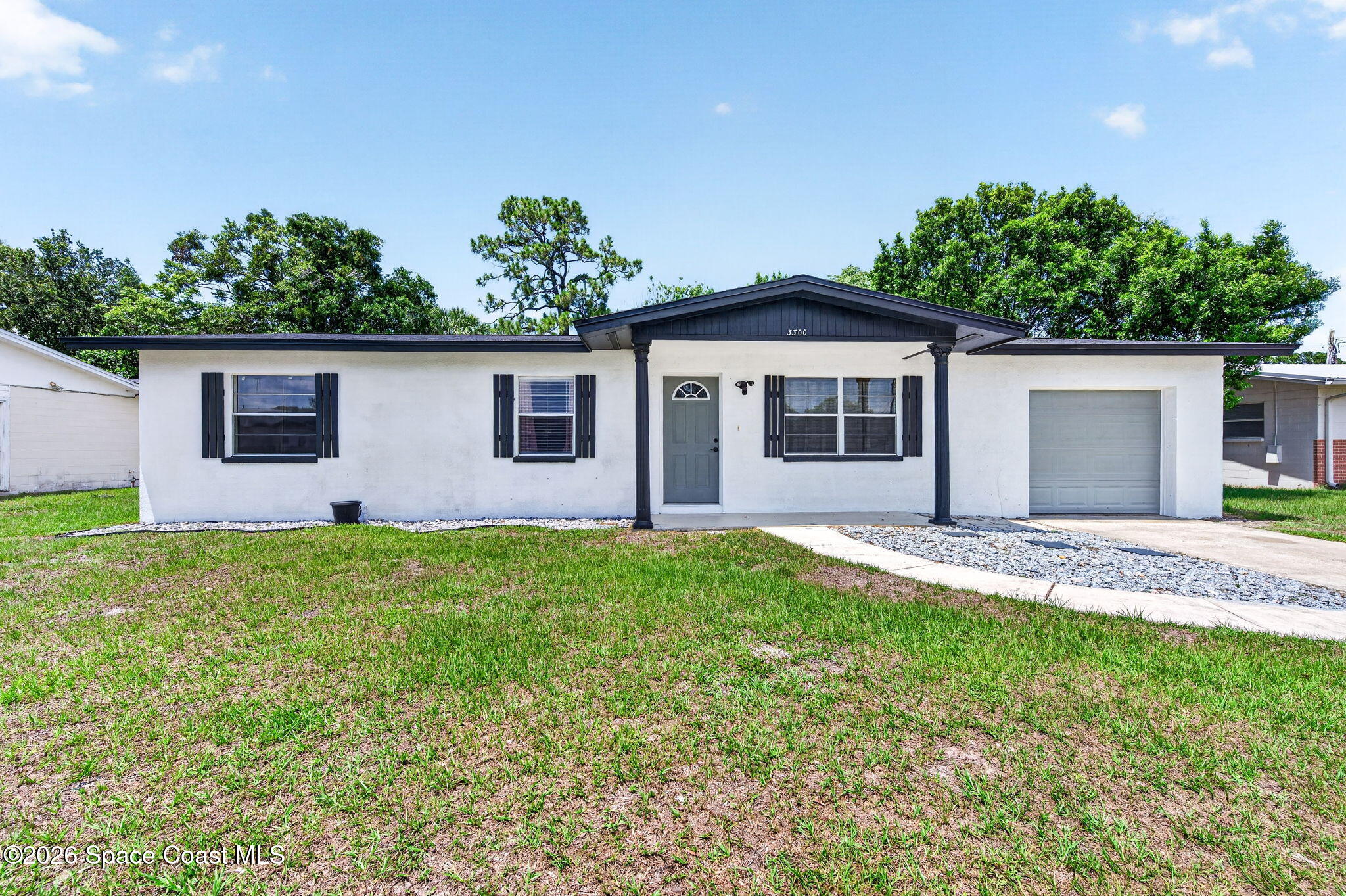 3300 Argyle Road Titusville, FL 32796 - Photo 2 of 29 a front view of house with yard and trees