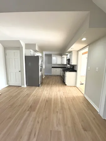 a view of a kitchen with a sink and a refrigerator