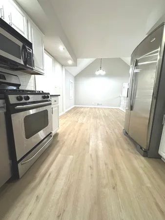 a view of a kitchen with a stove cabinets and a wooden floor