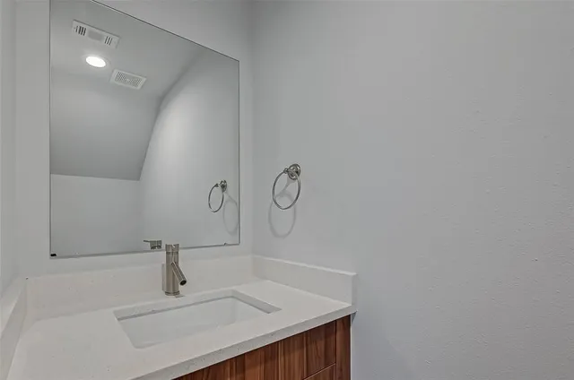 a bathroom with a sink and vanity