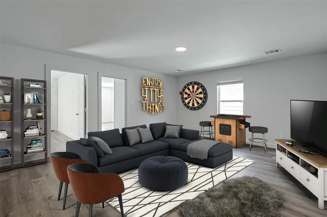 a living room with furniture a rug and a flat screen tv