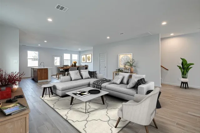a living room with furniture potted plant and a window