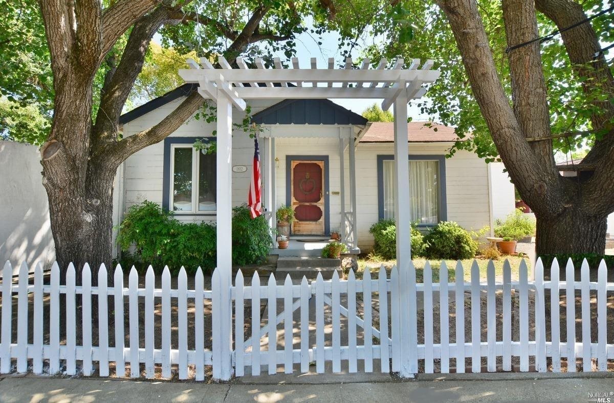 a front view of a house with wooden fence