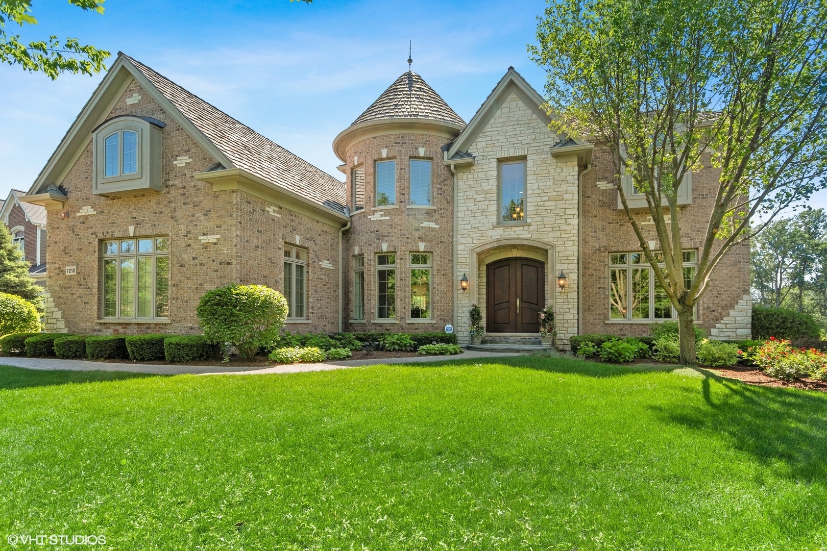 7212 Daybreak Lane Long Grove, IL 60060 - Photo 1 of 1 a front view of a house with a garden and plants