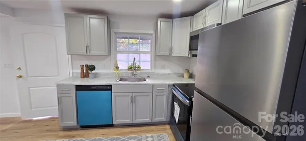 a kitchen with a sink cabinets and window