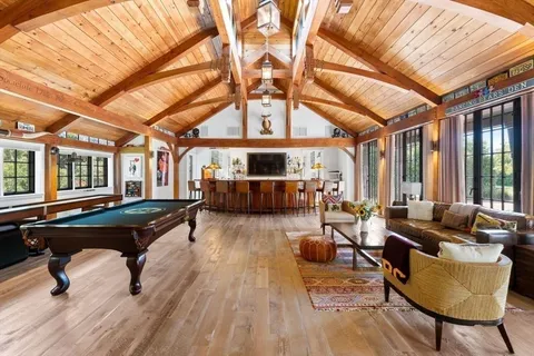 a living room with furniture and wooden floors