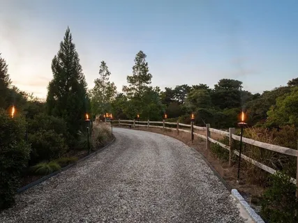 a view of a big yard with a house in the background