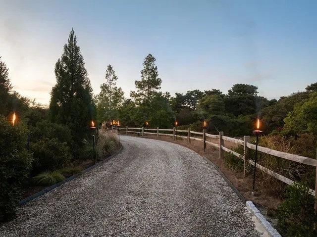 a view of a big yard with a house in the background