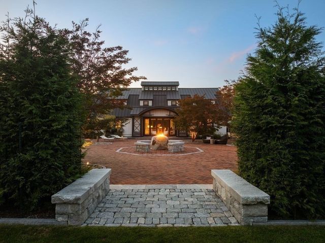 a en suite bathroom with a double vanity sink a mirror and a window