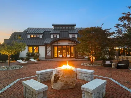a view of a building with swimming pool and sitting area