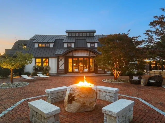 a view of a building with swimming pool and sitting area