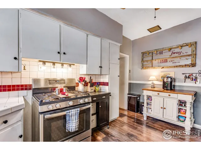a kitchen with stainless steel appliances a stove a sink cabinets and a refrigerator