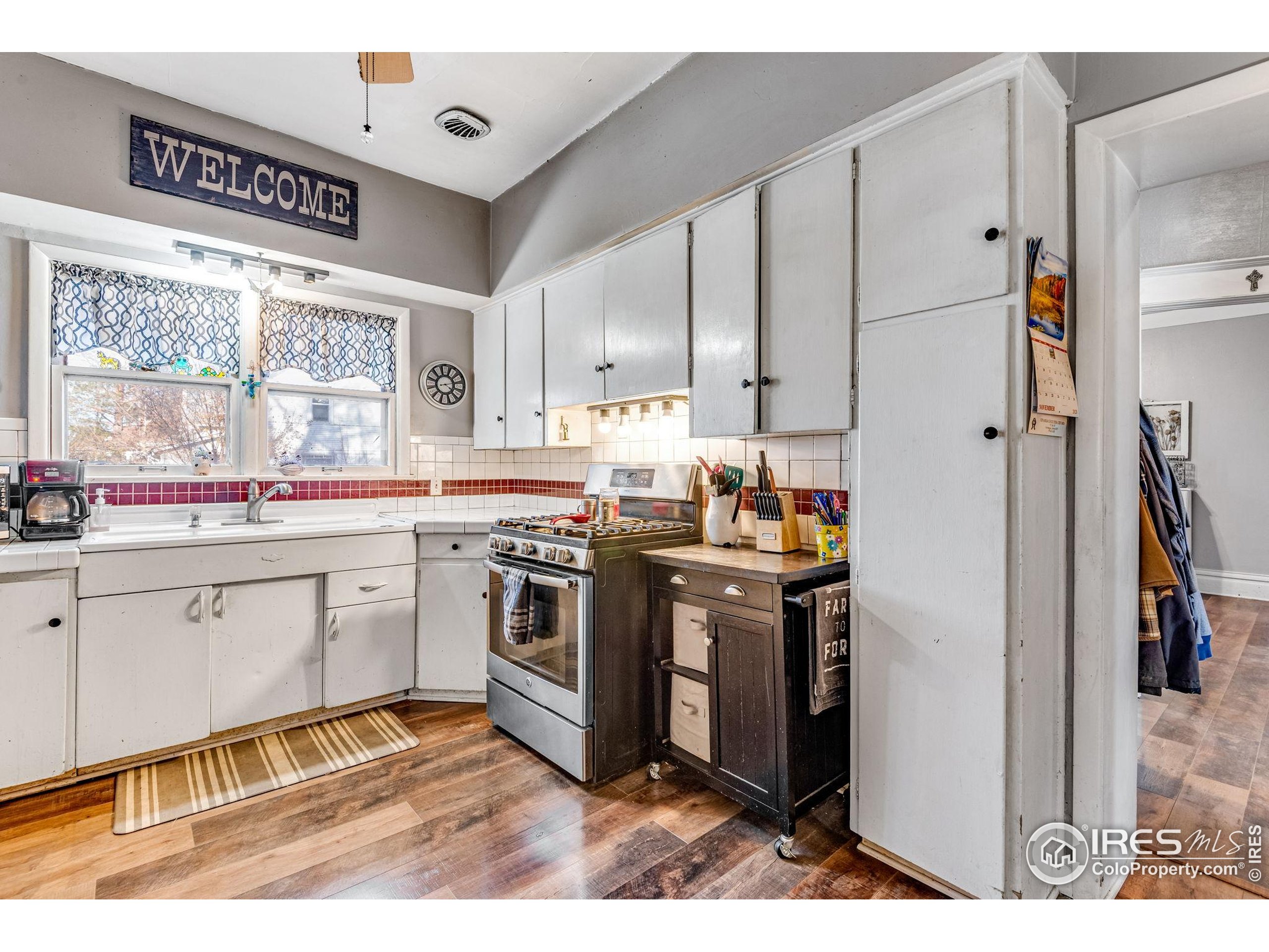 501 Maple Street Fort Morgan, CO 80701 - Photo 22 of 46 a kitchen with stainless steel appliances granite countertop a stove a sink and a refrigerator