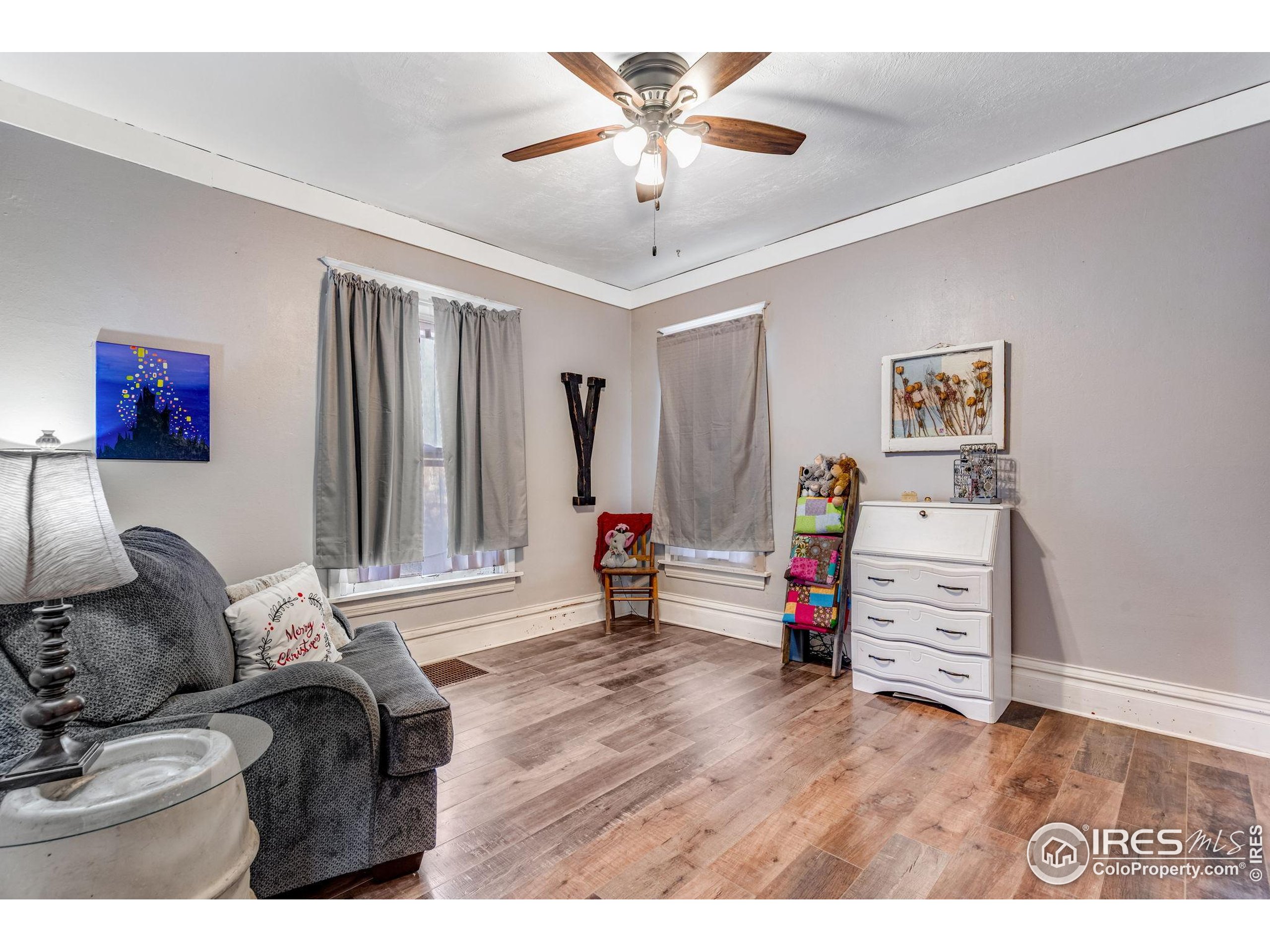 501 Maple Street Fort Morgan, CO 80701 - Photo 26 of 46 a living room with furniture and wooden floor