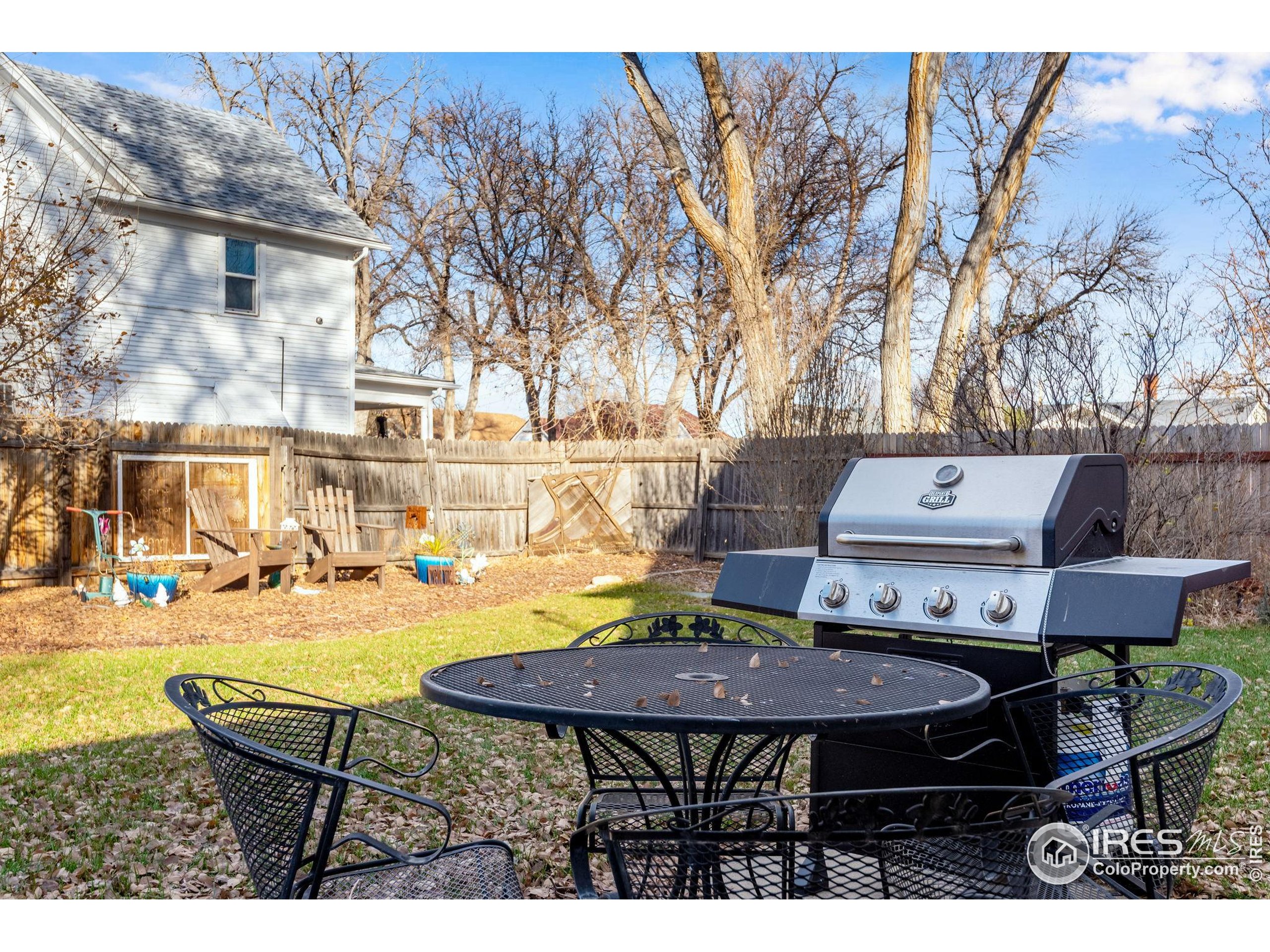 501 Maple Street Fort Morgan, CO 80701 - Photo 45 of 46 a view of a patio with table and chairs with wooden floor