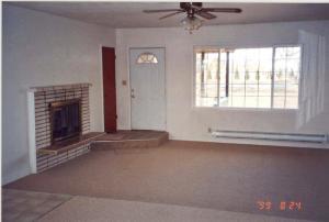 2813 Birchfield Road Yakima, WA 98901 - Photo 7 of 9 an empty room with a fireplace and windows