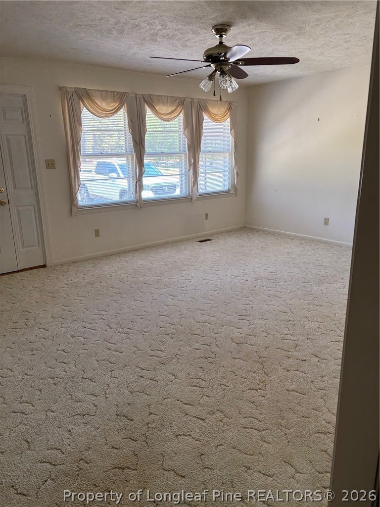 1523 Proctorville Church Road Proctorville, NC 28369 - Photo 13 of 35 an empty room with windows and fan