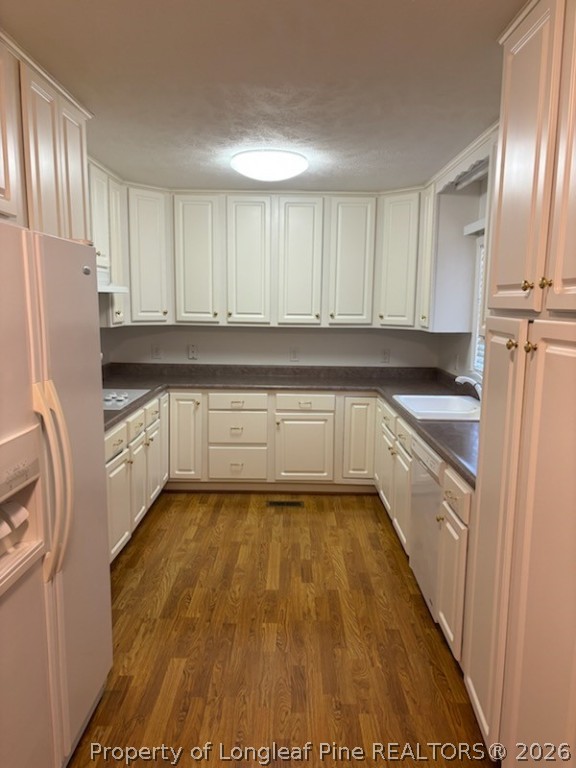 1523 Proctorville Church Road Proctorville, NC 28369 - Photo 16 of 34 a kitchen with granite countertop a refrigerator a sink and white cabinets