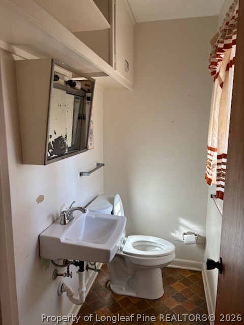 1523 Proctorville Church Road Proctorville, NC 28369 - Photo 32 of 34 a bathroom with a toilet a sink and mirror