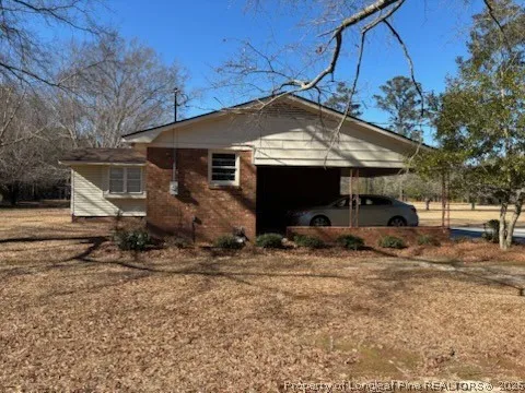a view of a house with a yard and sitting area