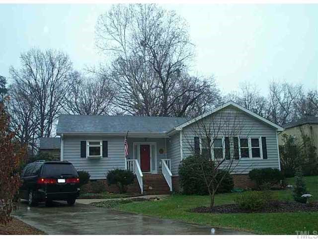 5217 Vann Street Raleigh, NC 27606 - Photo 1 of 1 a front view of a house with a yard and trees