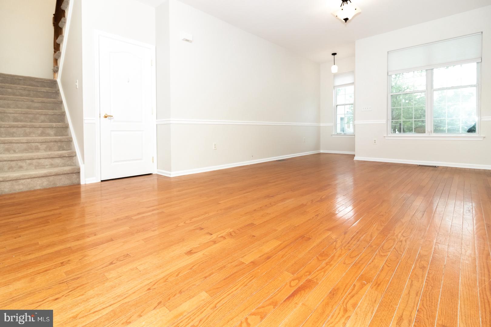 226 Hawthorne Way Riverside, NJ 08075 - Photo 4 of 32 an empty room with wooden floor and windows
