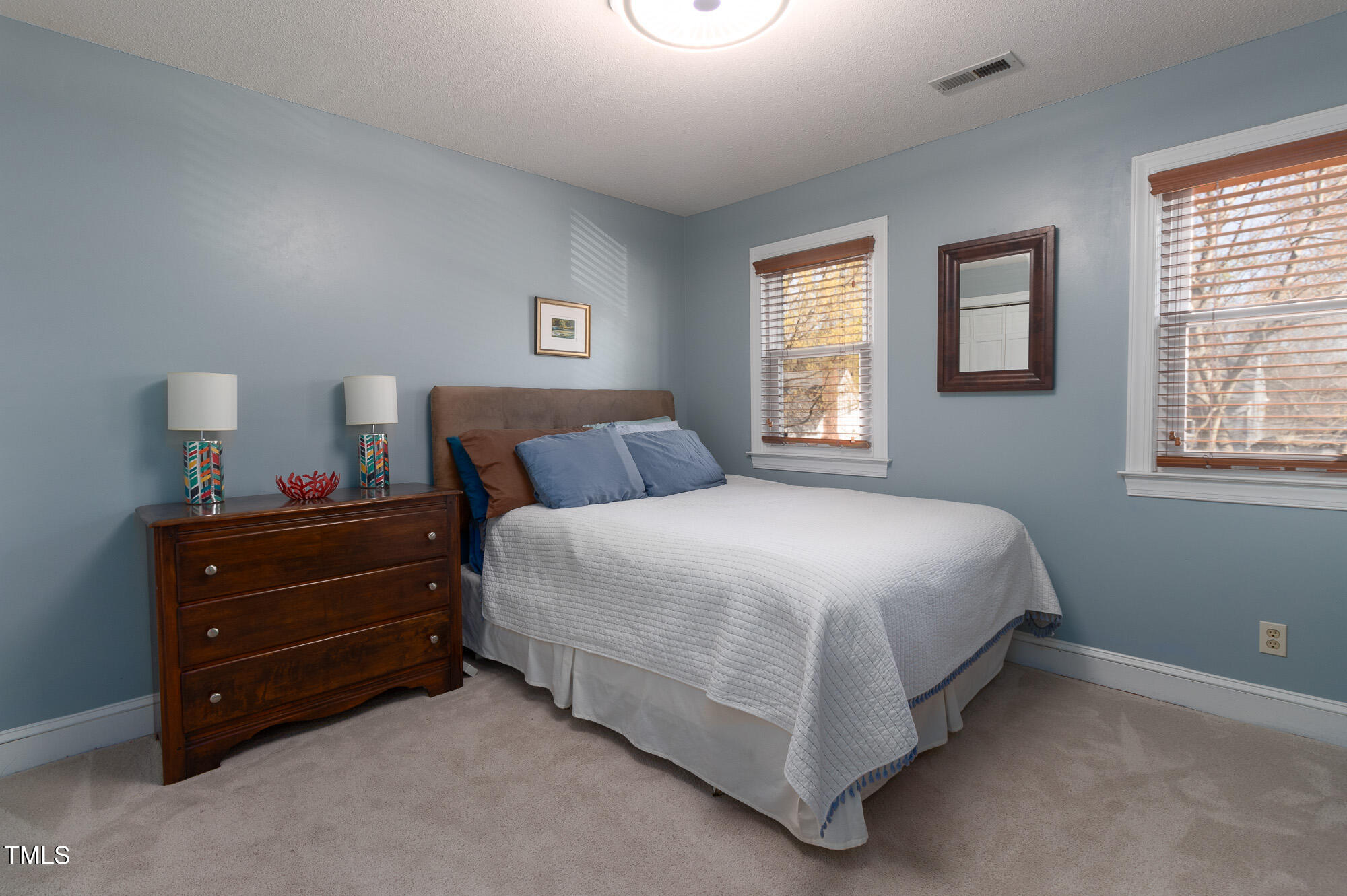 8832 Campfire Trail Raleigh, NC 27615 - Photo 11 of 19 a bedroom with a bed and a window