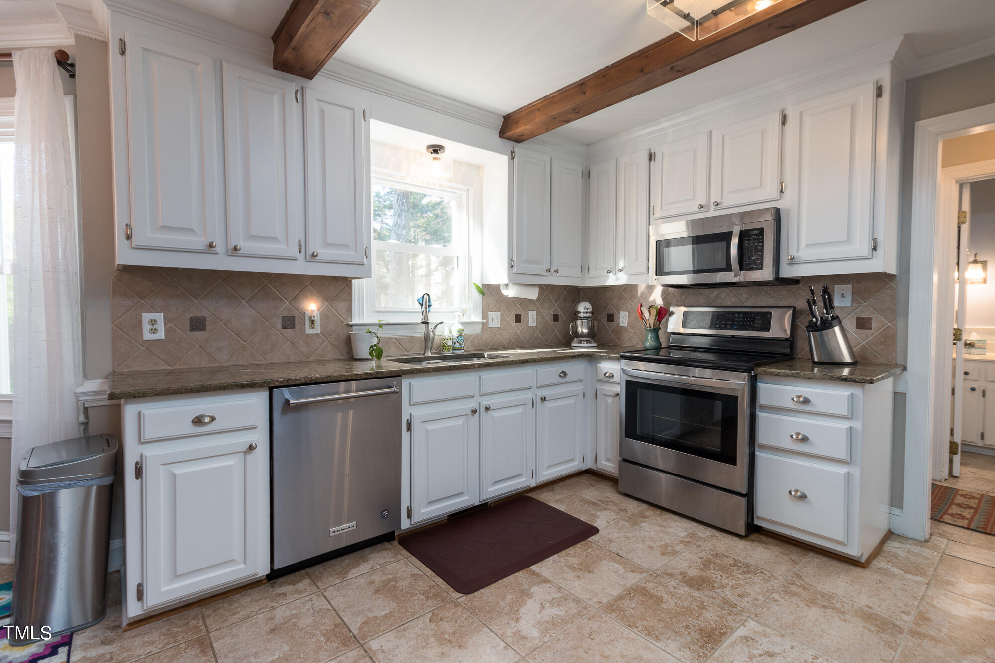 8832 Campfire Trail Raleigh, NC 27615 - Photo 3 of 19 a kitchen with cabinets appliances and a window